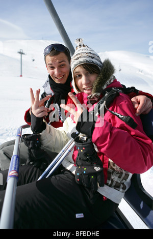 Young couple riding a ski lift Stock Photo