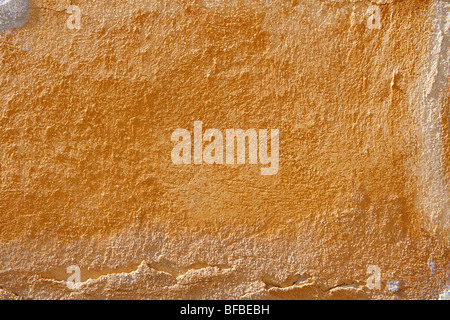Orange yellow painted plater wall with ageing paint surface, rustic texture Stock Photo