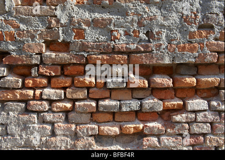 Close up of old red brick wall with damaged bricks, urban textures Stock Photo