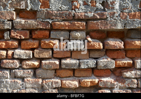 Close up of old red brick wall with damaged bricks, urban textures Stock Photo
