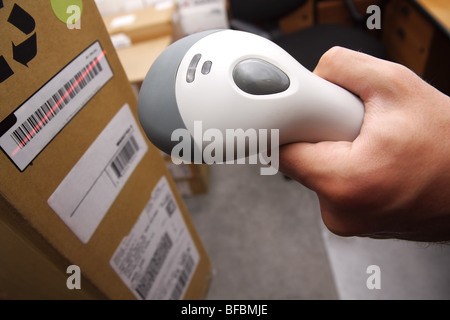 A man gets on the hip scaner in operations directed on printed barcode. Warehouse scene. Stock Photo
