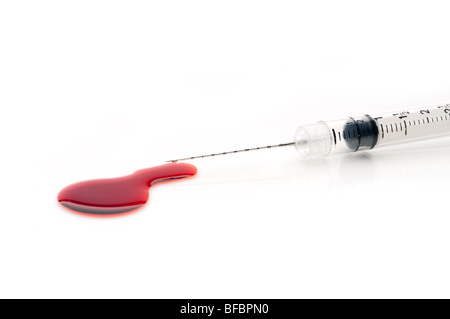 Medical syringe and pooled blood Stock Photo