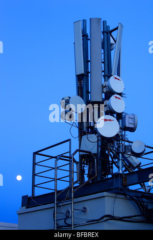 Mobile phone antennas on the roof of a building with full moon, Barcelona, Barcelona, Catalonia, Spain Stock Photo