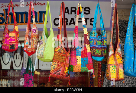 Colourful Indian fabric patchwork shoulder bags hanging at the front of a shop in India Stock Photo