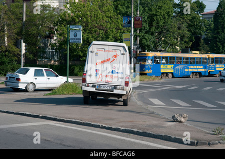 Illegally parked white courier van on pavement in Debrecen Hungary Eastern Europe Stock Photo