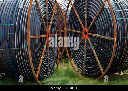 Spools of solid wall high density polyethylene (HDPE) conduit. Stock Photo