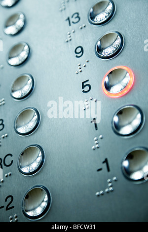 close up of elevator keypad with glowing button Stock Photo