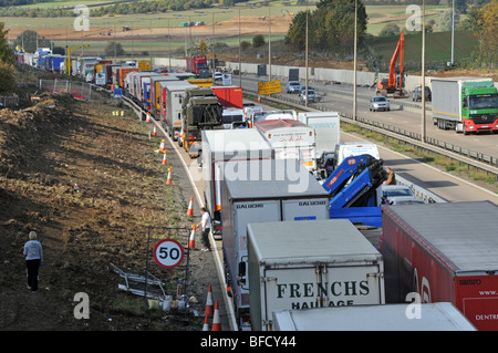 Motorists out of their vehicles in gridlocked traffic on M25 motorway roadworks section after closing due to accident Stock Photo