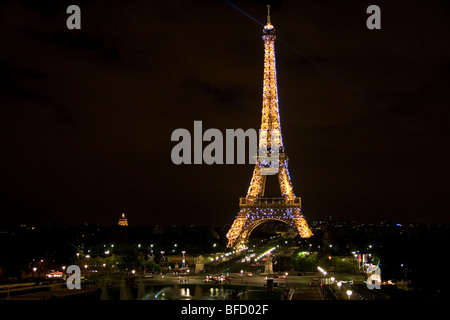 The Eiffel Tower lit up at night located on the Champ de Mars in Paris, France. Stock Photo