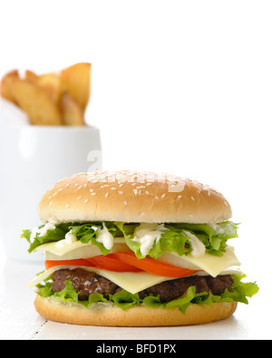 Hamburger with fries in background on white table Stock Photo