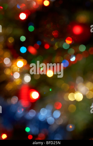 defocussed out of focus christmas fairy lights hanging on a christmas tree Stock Photo