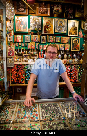 Shop assistant at jewellery / gift / souvenir stall in the Sukiennice (Cloth Hall, Drapers' Hall) Market Square, Krakow. Poland. Stock Photo