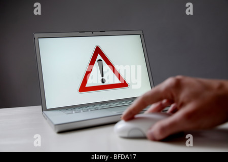 Warning sign on computer screen Stock Photo