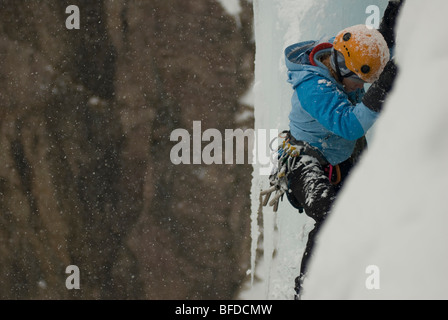 A professional female climber ice climbing at Ouray Ice Park in Ouray, Colorado. Stock Photo