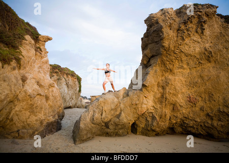 A young woman preforming yoga on the beach Stock Photo - Alamy