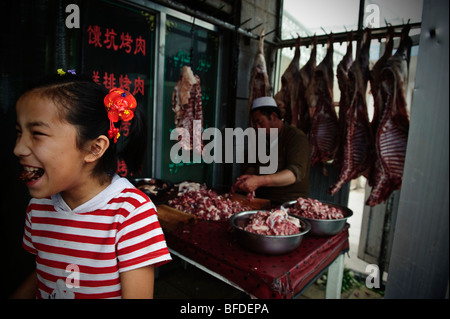 A girl at the entrance to a restaurant in Kashgar, Xinjiang, China. Stock Photo