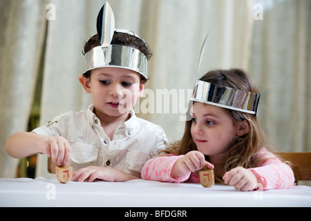 Boy and girl playing with a dreidel. Stock Photo