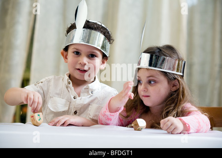 Boy and girl playing with a dreidel. Stock Photo