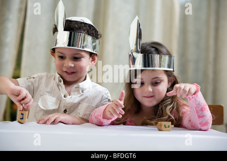 Boy and girl playing with a dreidel. Stock Photo