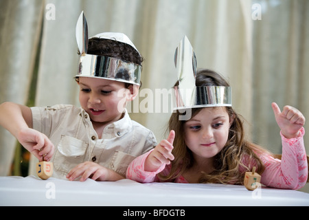 Boy and girl playing with a dreidel. Stock Photo