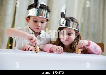 Boy and girl playing with a dreidel. Stock Photo