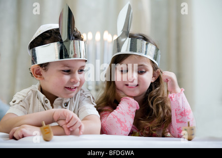 Boy and girl playing with a dreidel. Stock Photo