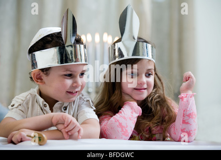 Boy and girl playing with a dreidel. Stock Photo