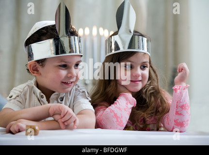 Boy and girl playing with a dreidel. Stock Photo