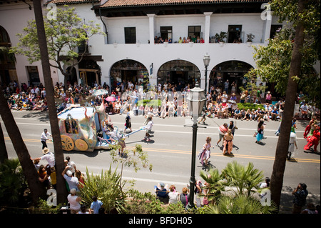 Crowds enjoy an annual parade in Santa Barbara. The parade features extravagant floats and costumes. Stock Photo