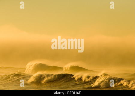 Waves crash to the beach at Cape Agulhas at the southern tip of Cape Town, South Africa. Stock Photo