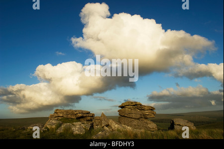 White cumulus clouds billowing over granite stack known as Black Tor, Dartmoor, Devon UK Stock Photo