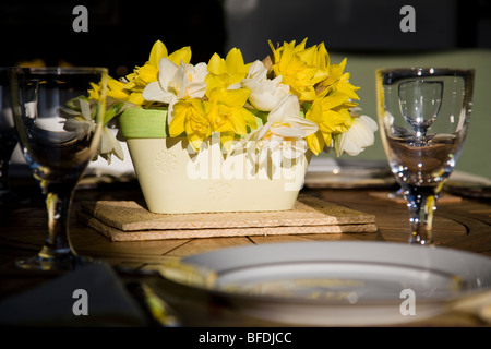 Close-up of a flower display and table setting. Stock Photo