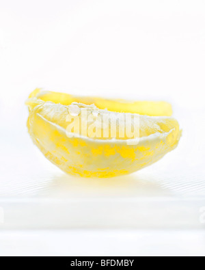 Lemon wedge on a cutting board Stock Photo