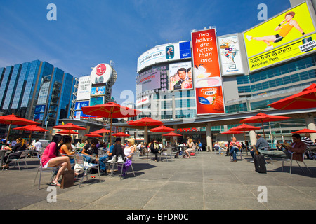 People relaxing in city plaza, Yonge-Dundas Square, downtown, Toronto, Ontario, Canada Stock Photo