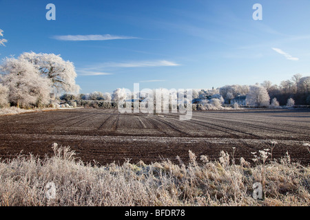 In the deep mid winter - earth stood hard as iron - ploughed field in deep frost Scotland Stock Photo
