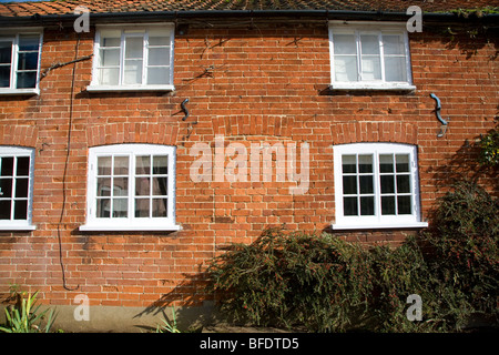 Bricked up cottage doorway part of a terraced row now converted into one house, Shottisham, Suffolk, England Stock Photo