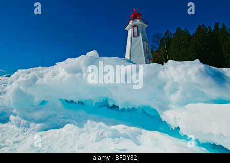 Lighthouse in winter at edge of Georgian Bay in Tobermory, Bruce Peninsula National Park, Ontario, Canada Stock Photo