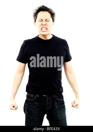 44 year old Asian male wearing jeans and a blue t-shirt standing against a white background screaming Stock Photo