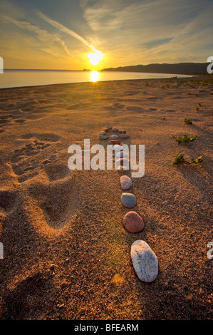 Arrow made from rocks along the beach in Agawa Bay at sunset, Lake Superior, Lake Superior Provincial Park, Ontario, Canada Stock Photo