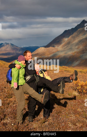 Hikers doing the can-can dance in the tundra of Tombstone Park, Yukon, Canada Stock Photo