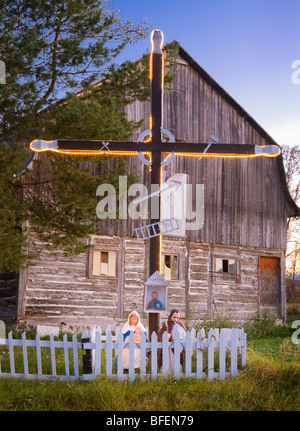 Cross and statues of the Virgin Mary, Joseph and baby Jesus along Route 362 in Les Ã‰boulements, Charlevoix, Quebec, Canada Stock Photo