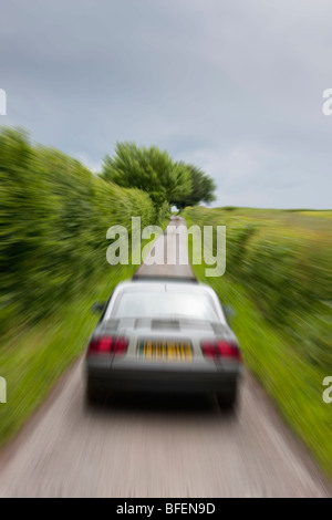 Car speeding in a country lane in England Stock Photo
