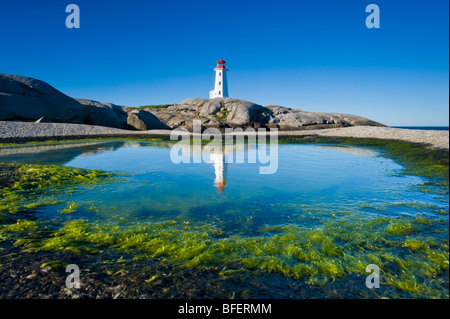 Lighthouse reflected in tide pool, Peggy's Cove, Nova Scotia, Canada Stock Photo