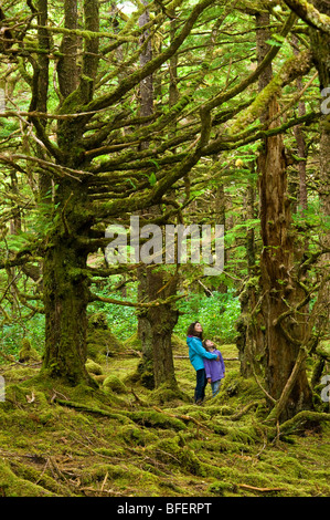 Mother and daughter in mossy forest, Naikoon Provincial Park, Queen Charlotte Islands, British Columbia, Canada Stock Photo