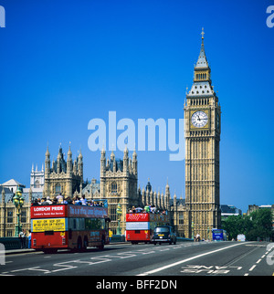 Red sightseeing double decker buses on Westminster bridge and Westminster Palace with Big Ben London Great Britain Stock Photo