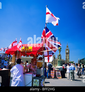 Ice cream merchant at Westminster bridge flags and Big Ben clock tower London Great Britain Europe Stock Photo