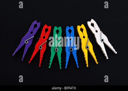 Multicolor laundry clips on black background Stock Photo
