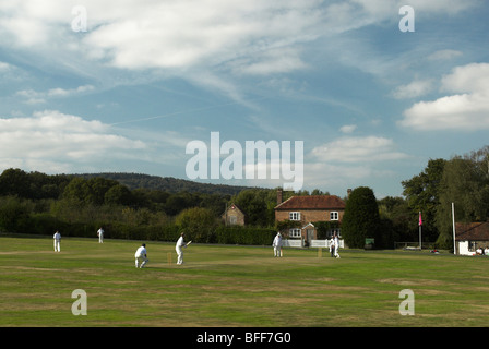 A quintessential English village green complete with a cricket match in play. Stock Photo