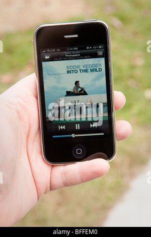 A man use the MP3 application on an Apple iPhone. Stock Photo
