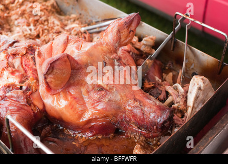 Pig's head roasted on spit Stock Photo